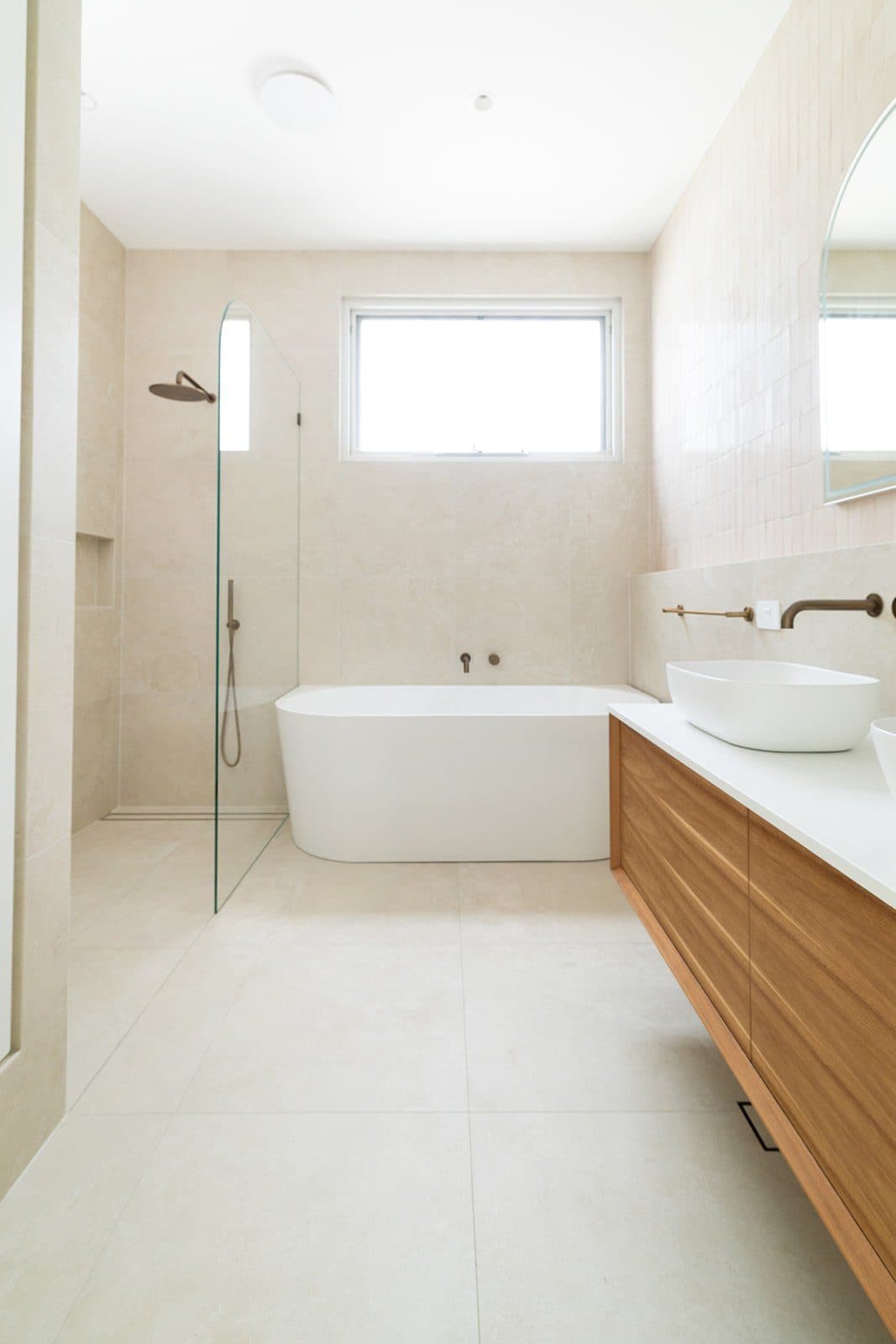 Freestanding bath, timber vanity and skylight — Allard Street bathroom by MBC