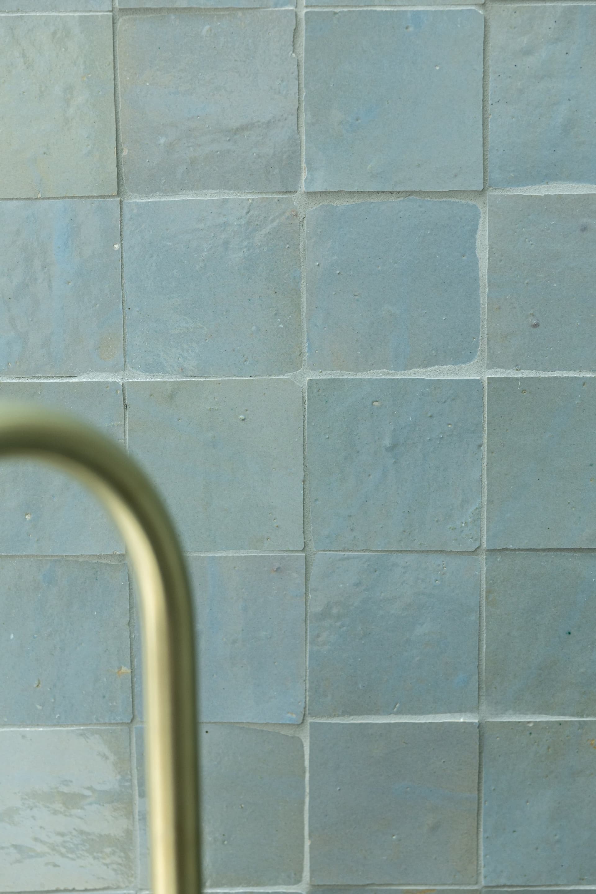 Zellige-tiled bathroom with brass tapware by MBC