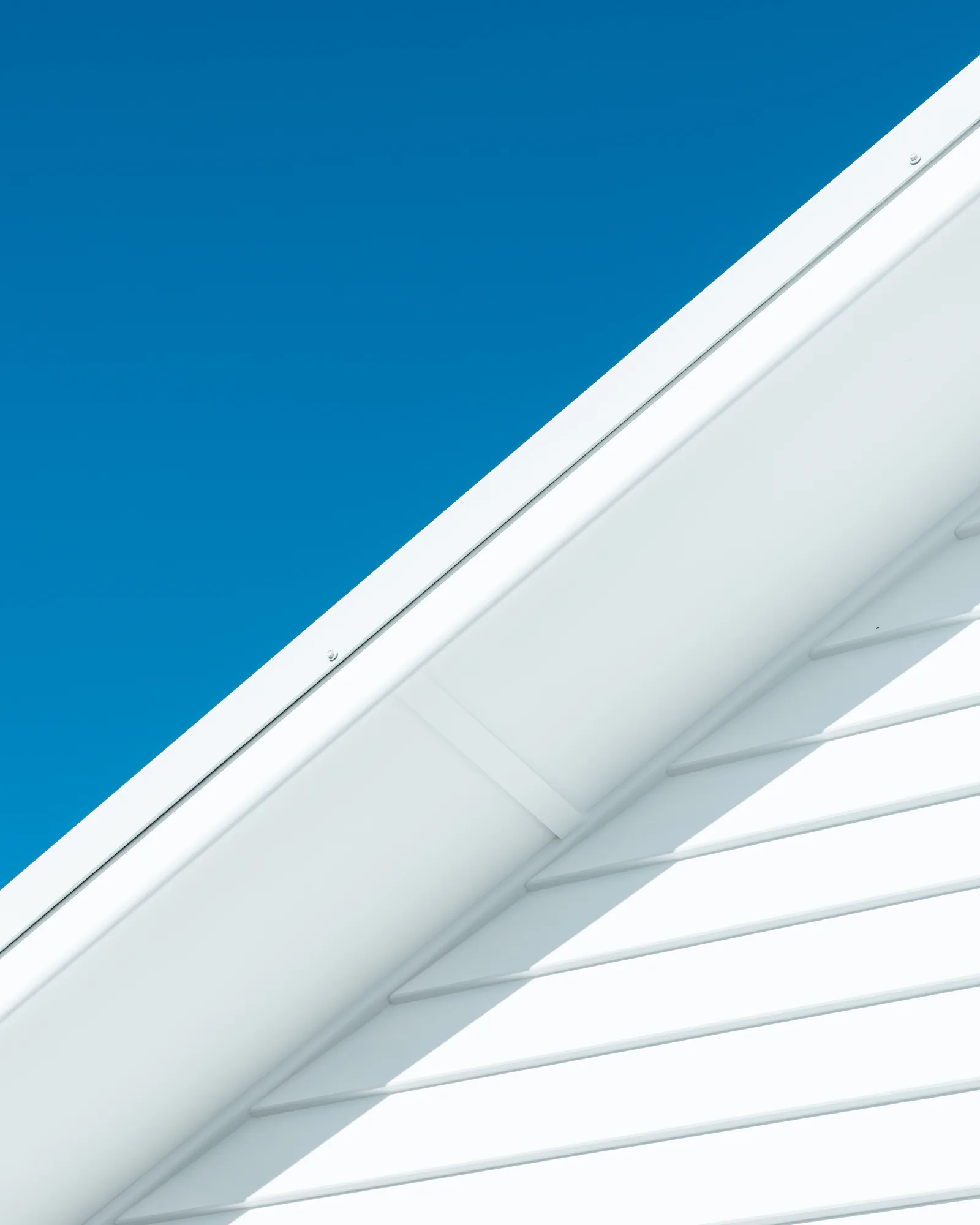 Roofline and eave detail against a clear blue sky at Dudley