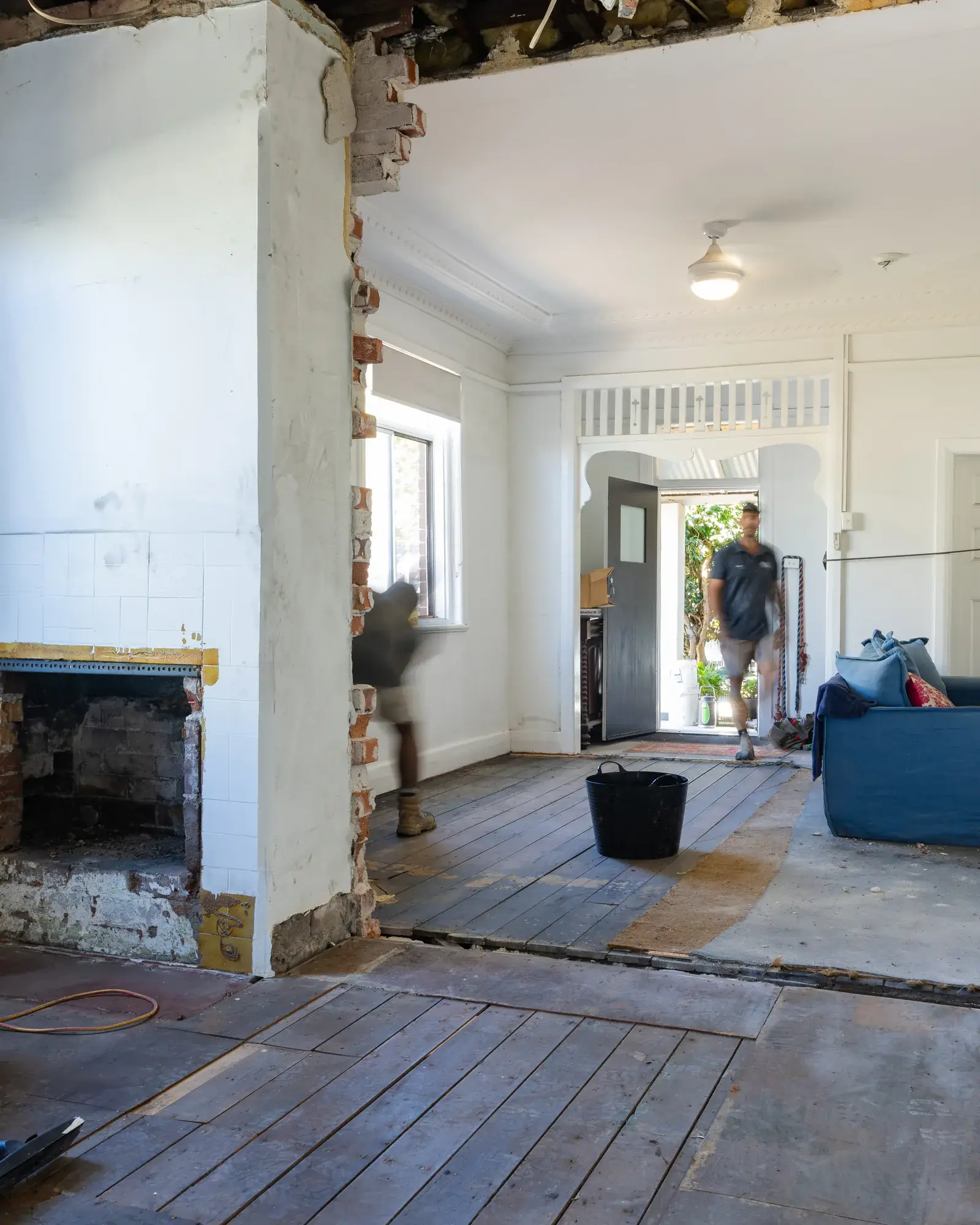 Mayfield renovation before — stripped hallway with original floorboards lifted and ceiling removed
